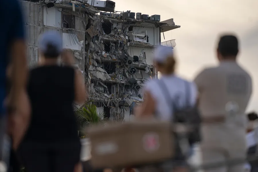 People watch the partially collapsed Champlain Towers in Surfside, Florida, north of Miami Beach.?w=200&h=150